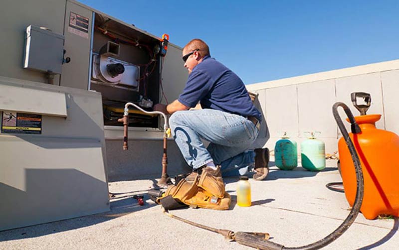 employee doing maintenance to a machine