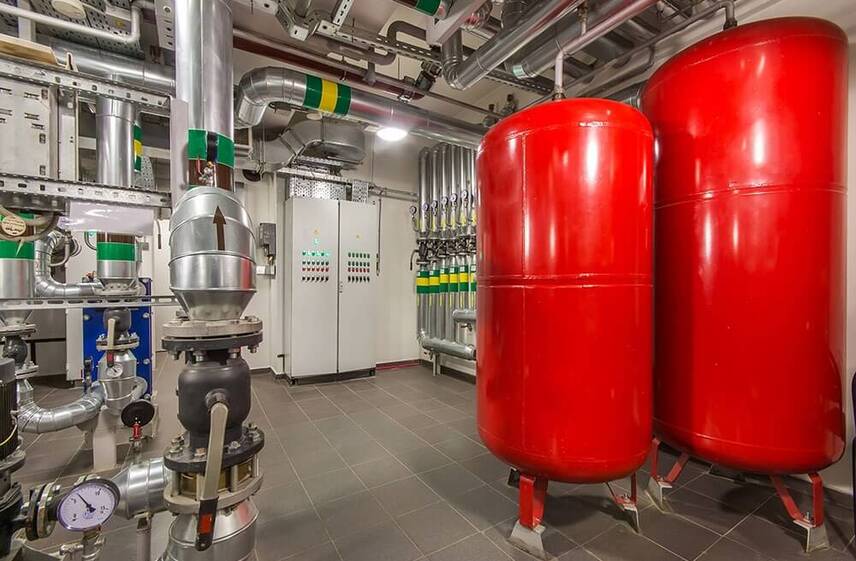 Dual red expansion tanks and control panel in Greensboro boiler repair facility