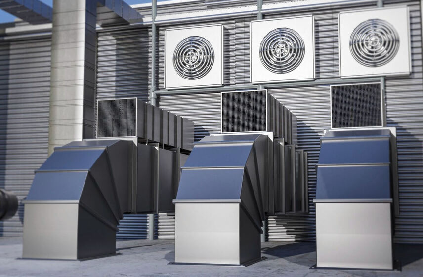 Industrial ductwork and exhaust fans requiring routine commercial air conditioner maintenance