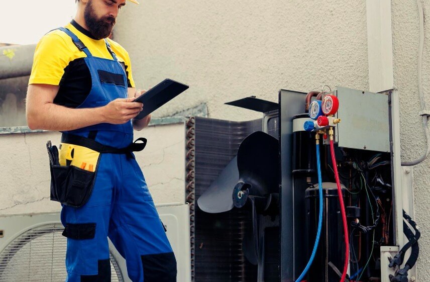 HVAC Contractor reviewing refrigerant gauges while delivering quality commercial HVAC services
