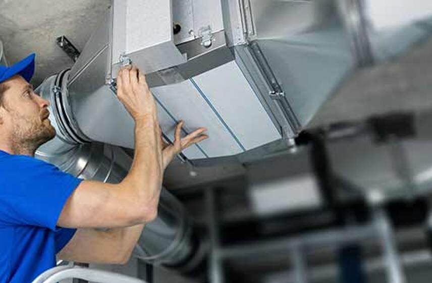 employee doing a maintenance to air quality machine 