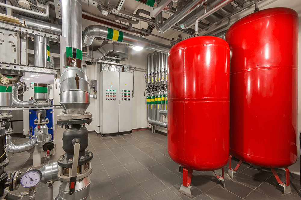 Dual red expansion tanks in commercial boiler room serviced in Wilmington, NC