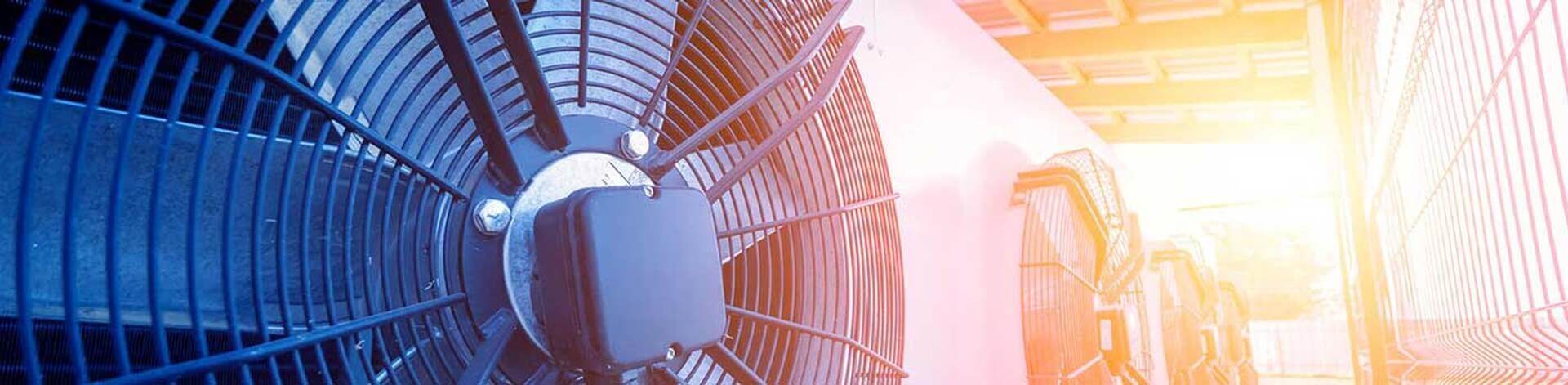 Close-up of commercial air conditioning condenser fans during AC maintenance service in Winston-Salem, NC